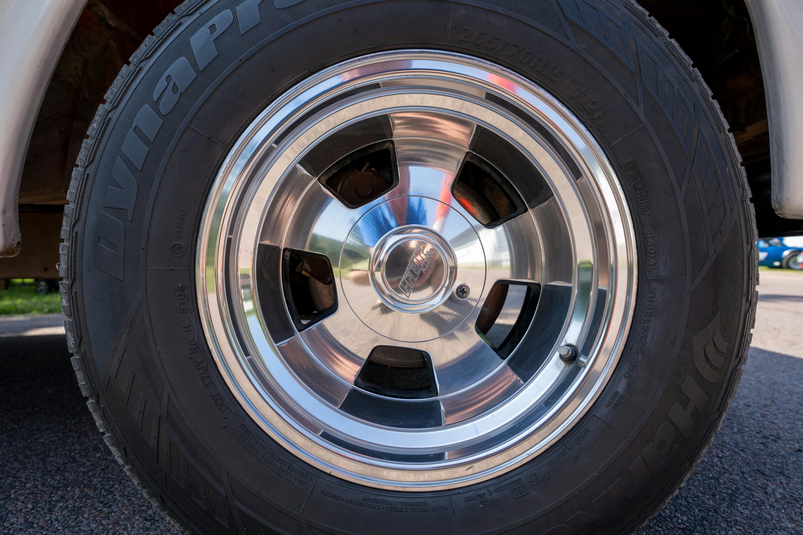 Chrome wheel with tire on a vintage vehicle